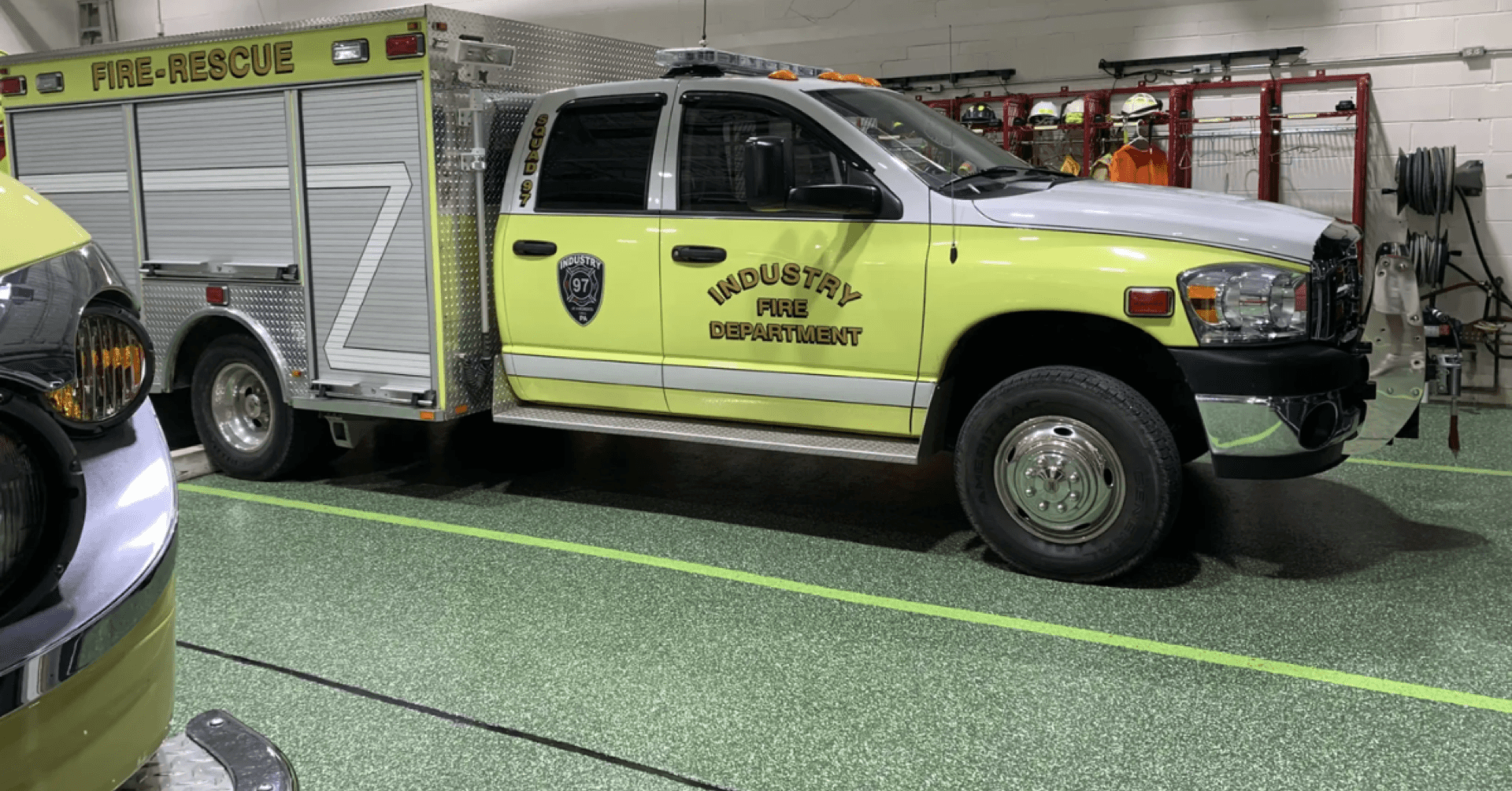 Fire-rescue truck on glossy green resin floor