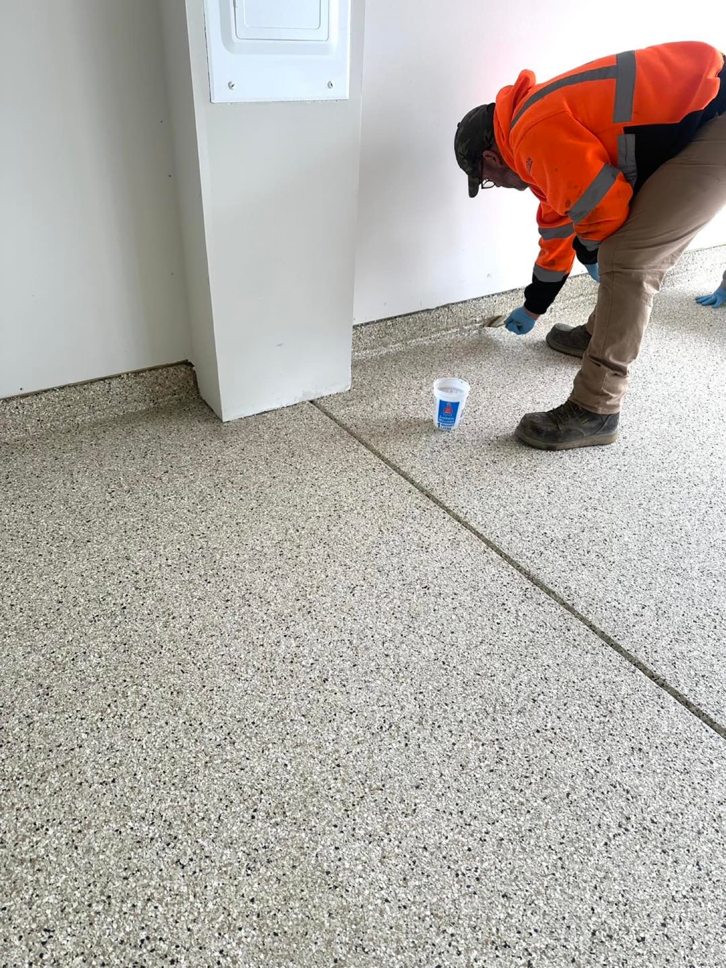 Close-up of crew member working detail on flake coating
