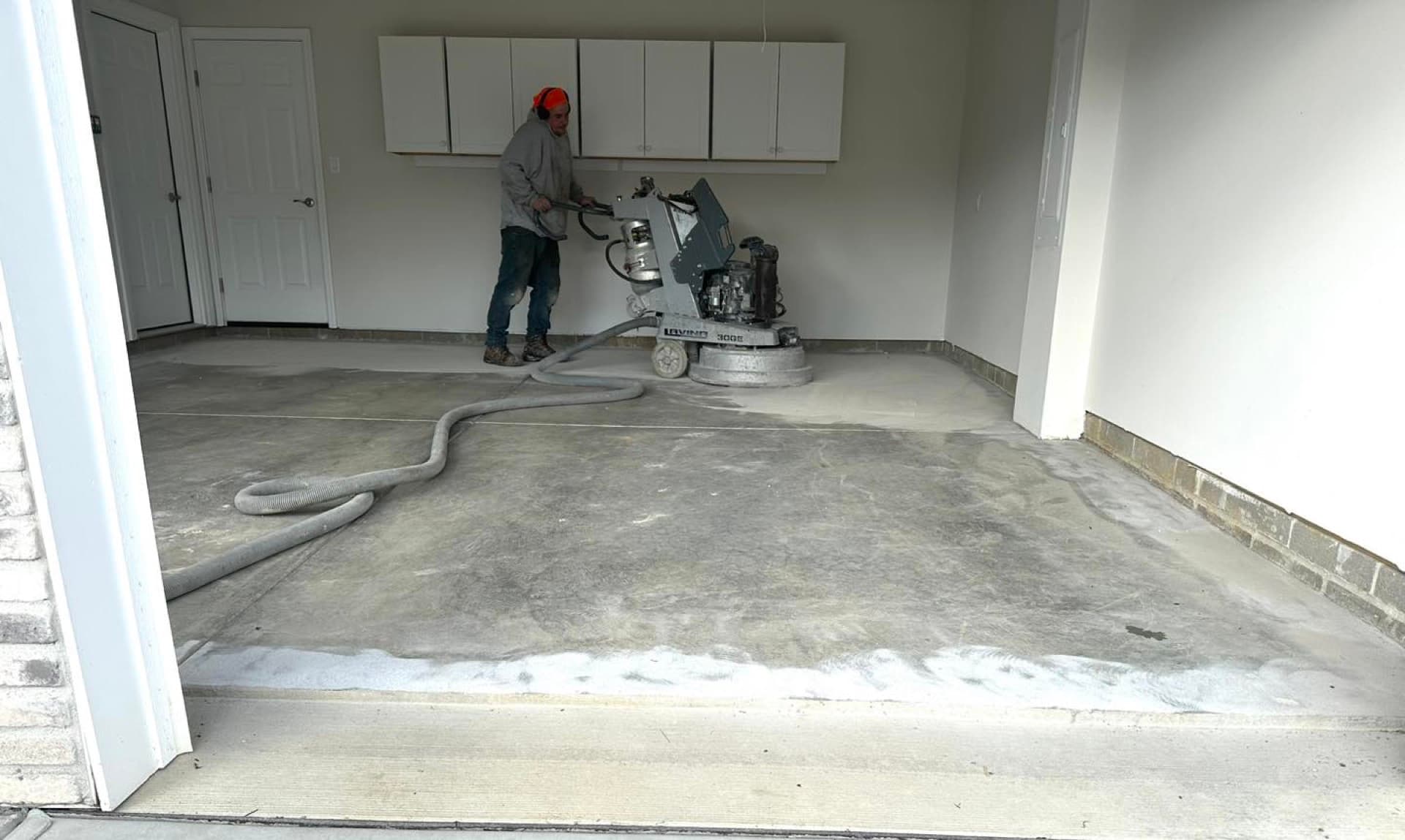 Diamond Coating crew member operating industrial grinder