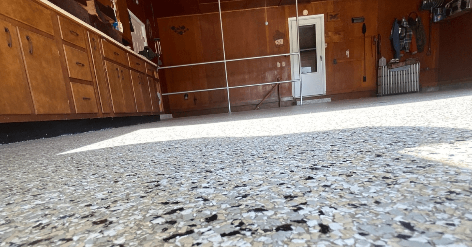 Gray flake coating in wood-panel garage