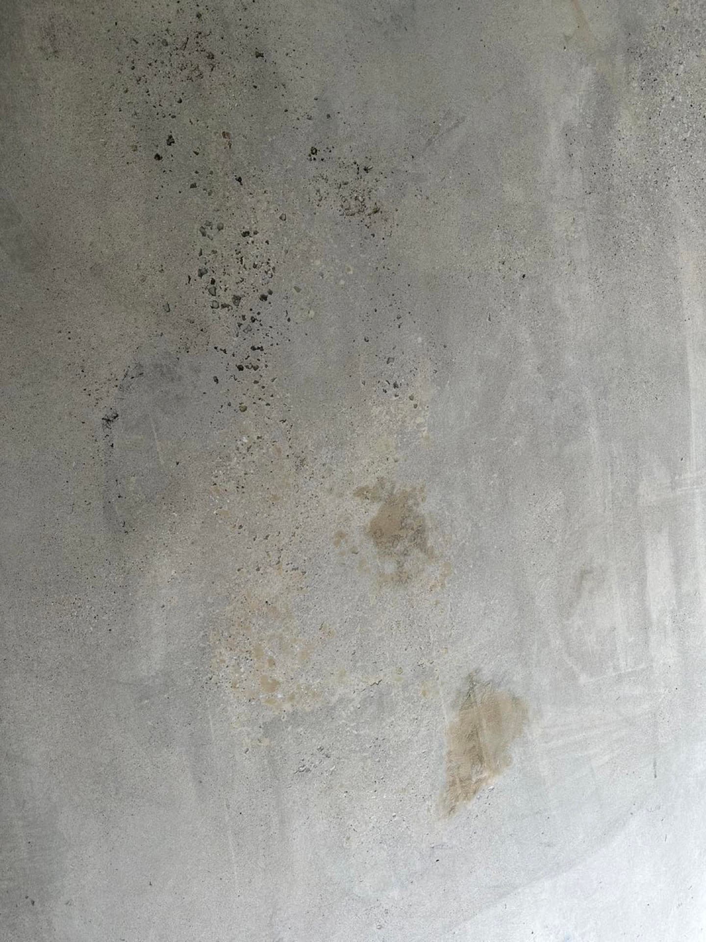 Stained garage floor with grinder ready for prep