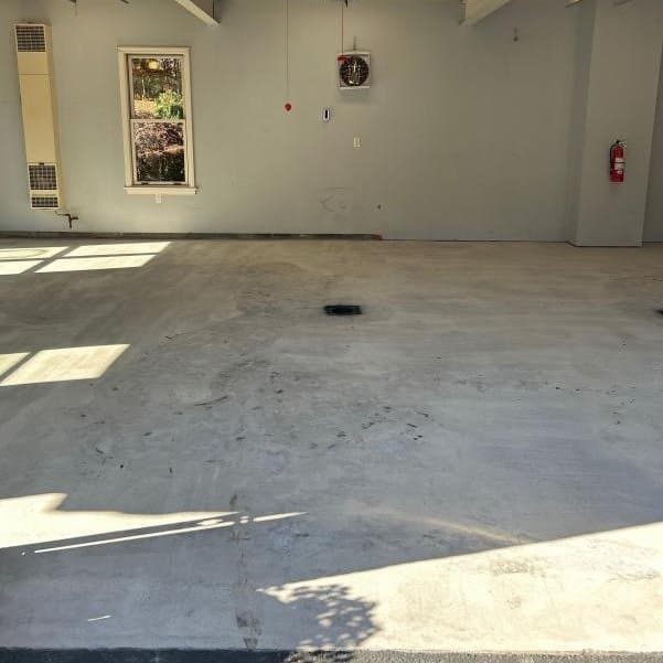 Before: bare stained concrete garage floor