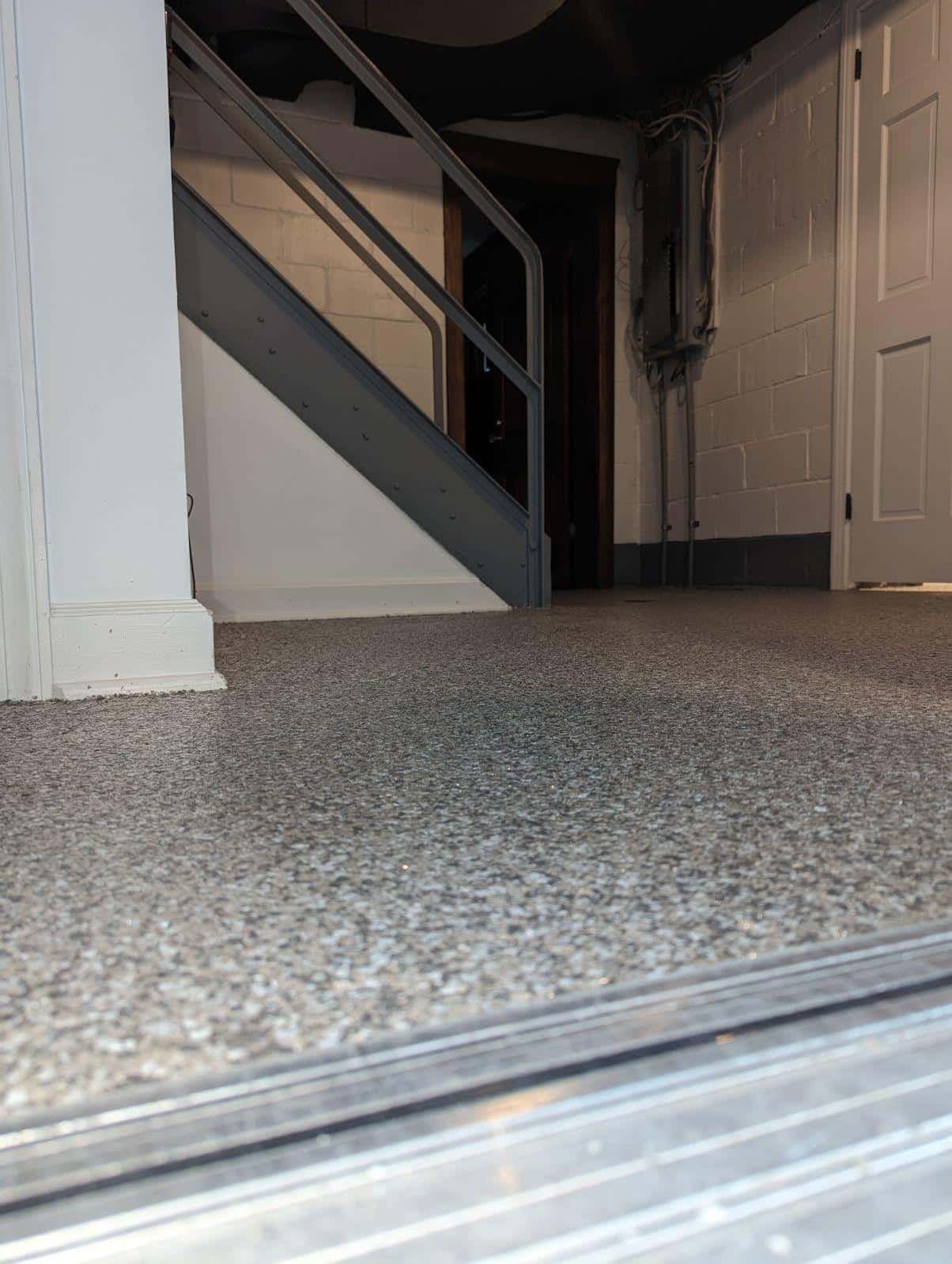 Wide finished basement with gray flake polyurea floor and staircase — Greater Cleveland, OH