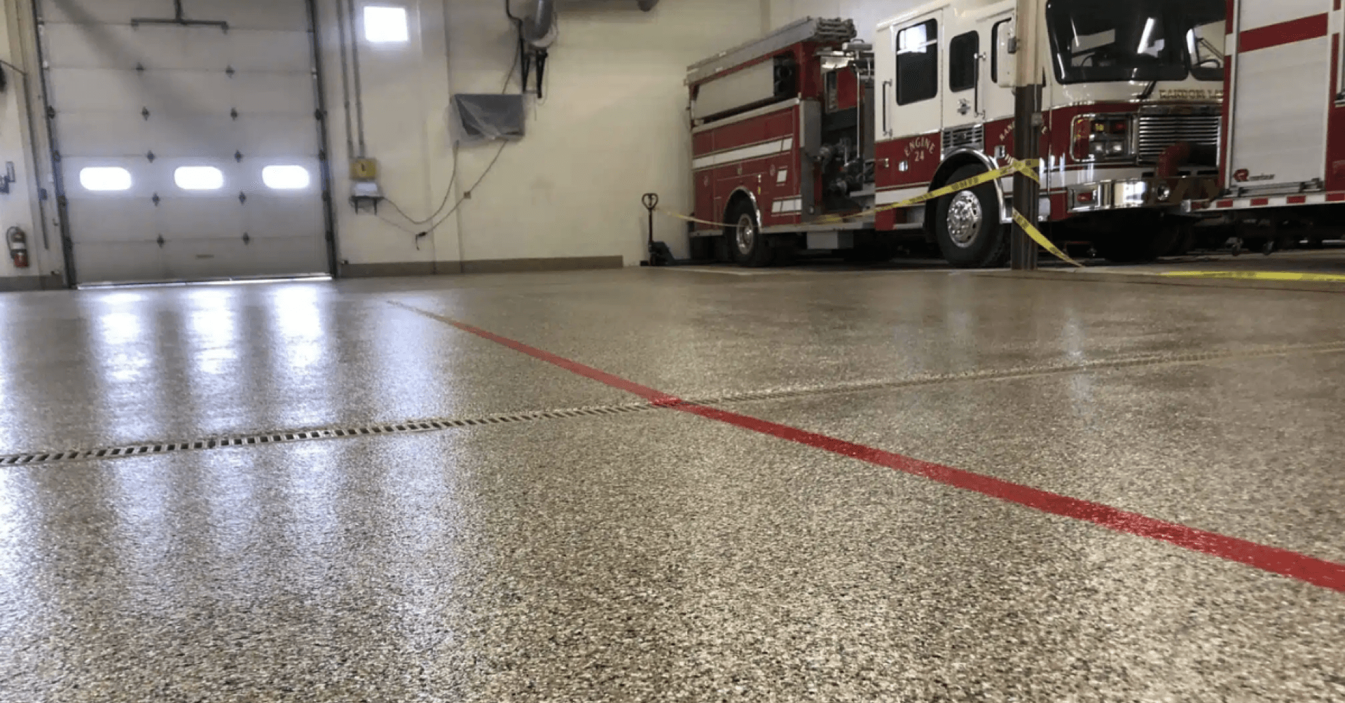 Fire station bay with red safety striping on polyurea resin floor — Greater Cleveland, OH