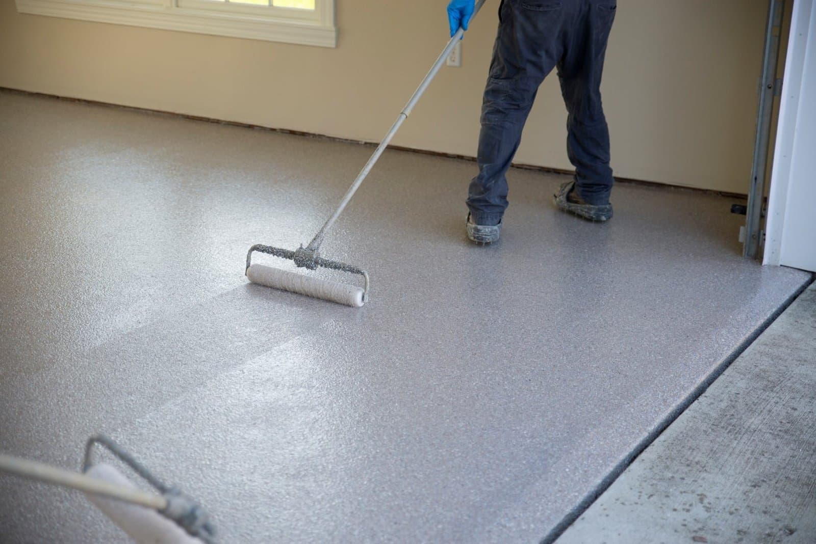 Diamond Concrete Coating crew rolling polyaspartic topcoat on a commercial floor — Cleveland, OH