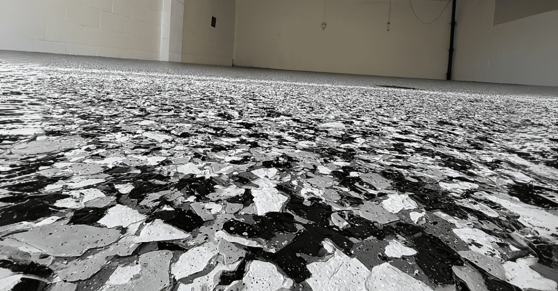 Close-up of gray decorative flake polyurea floor system installed in a Greater Cleveland OH basement