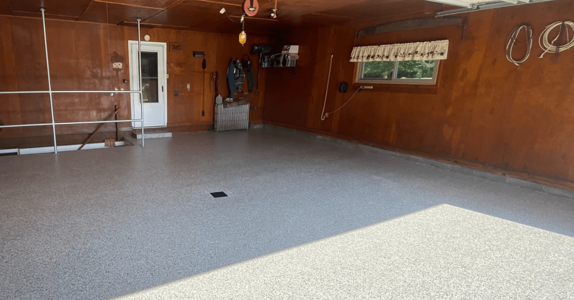 Low-angle view of glossy gray flake indoor floor coating — Strongsville, OH