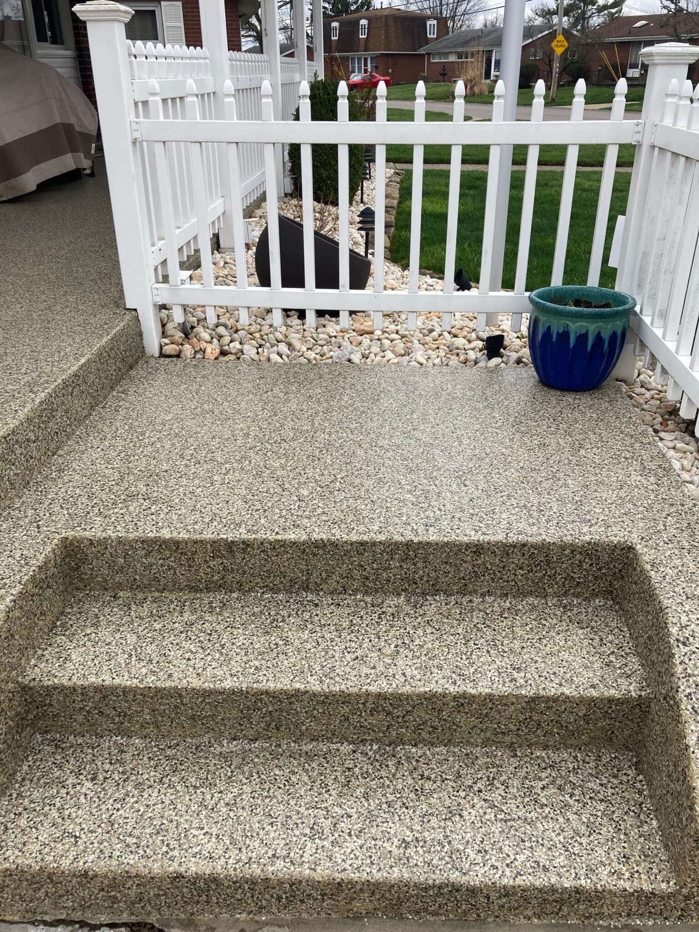 Sunny front entry with tan flake polyurea coating — Beachwood, OH