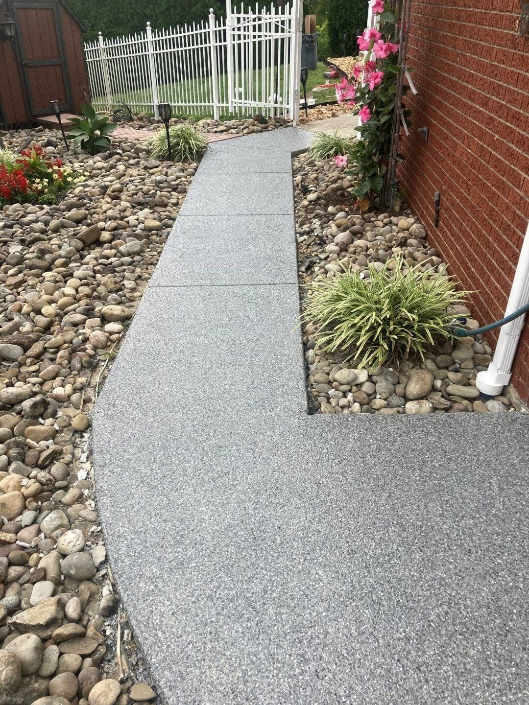 Curved coated concrete walkway through landscaping — Westlake, OH