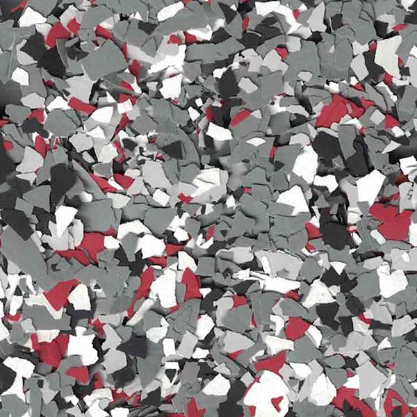 A mosaic of scattered, multicolored fragments in shades of gray, black, white, and red, resembling abstract debris or confetti on a surface.