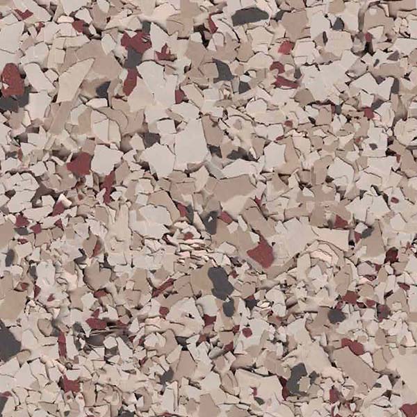 The image shows a close-up of a textured surface with scattered, irregularly shaped beige, red, and black flakes, resembling a decorative floor finish.