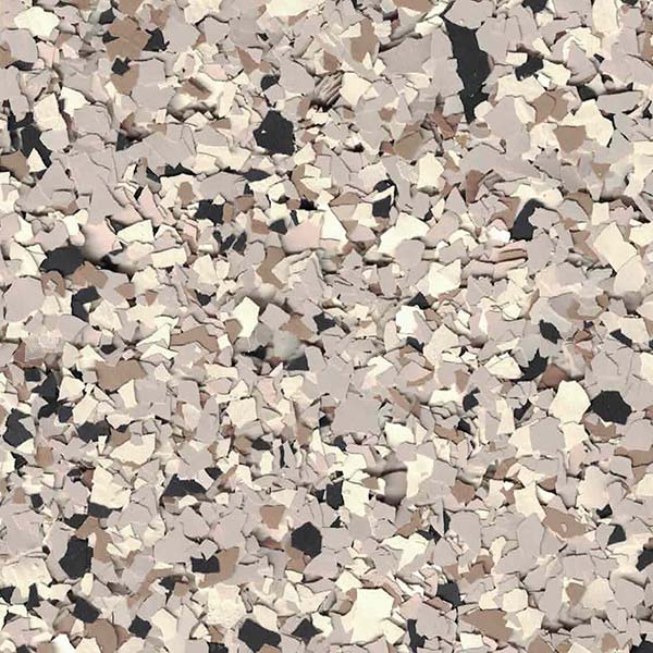 A textured surface filled with small, irregularly shaped flakes in shades of beige, brown, and black, creating a speckled, terrazzo-like appearance.