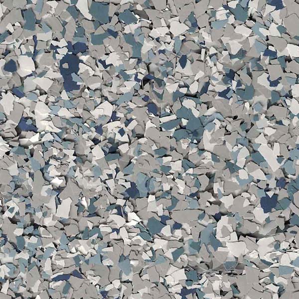 The image shows a close-up of a textured surface with scattered gray, blue, and white pieces, resembling a camouflage pattern.