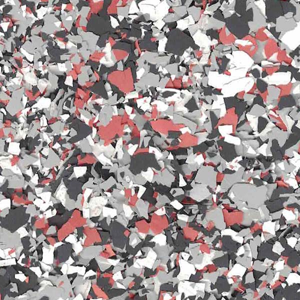 The image shows a textured surface with scattered, multicolored flakes in red, white, and gray, resembling a decorative flooring pattern.