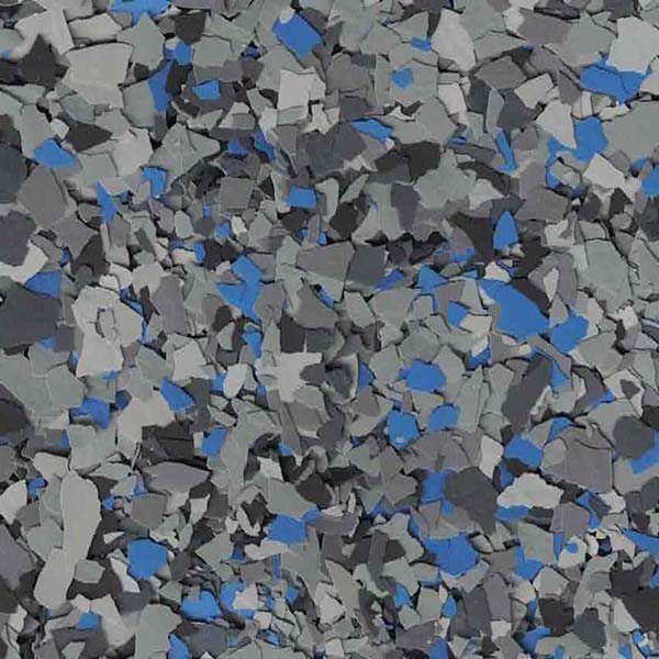 A textured surface with scattered blue, gray, and black fragments, resembling decorative chips often used in flooring or artistic applications.